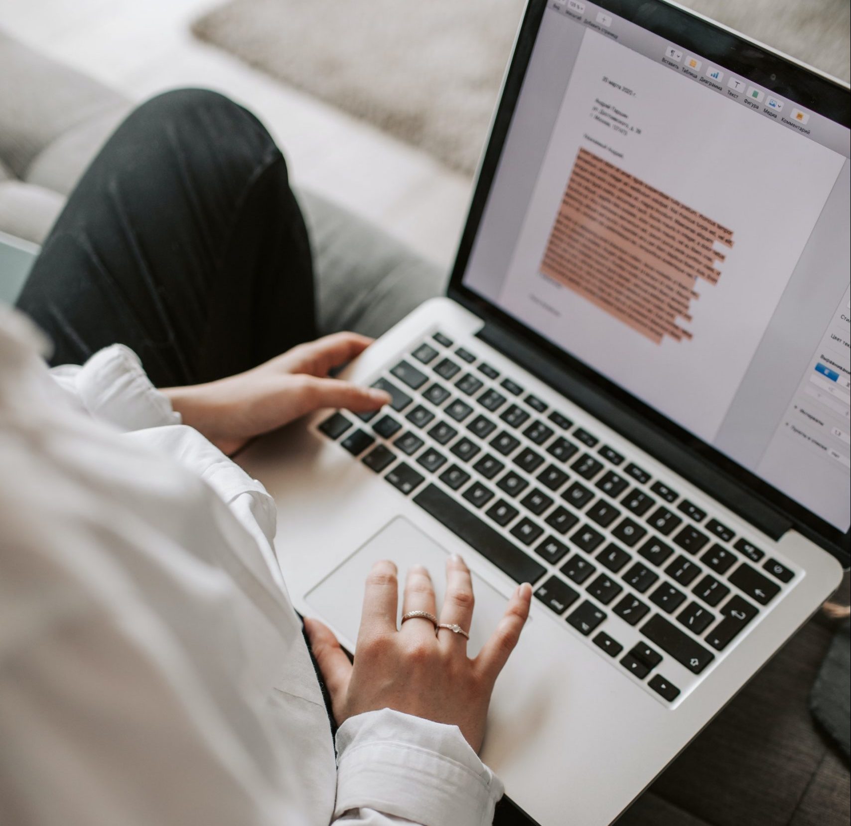 Woman writing a document on a laptop