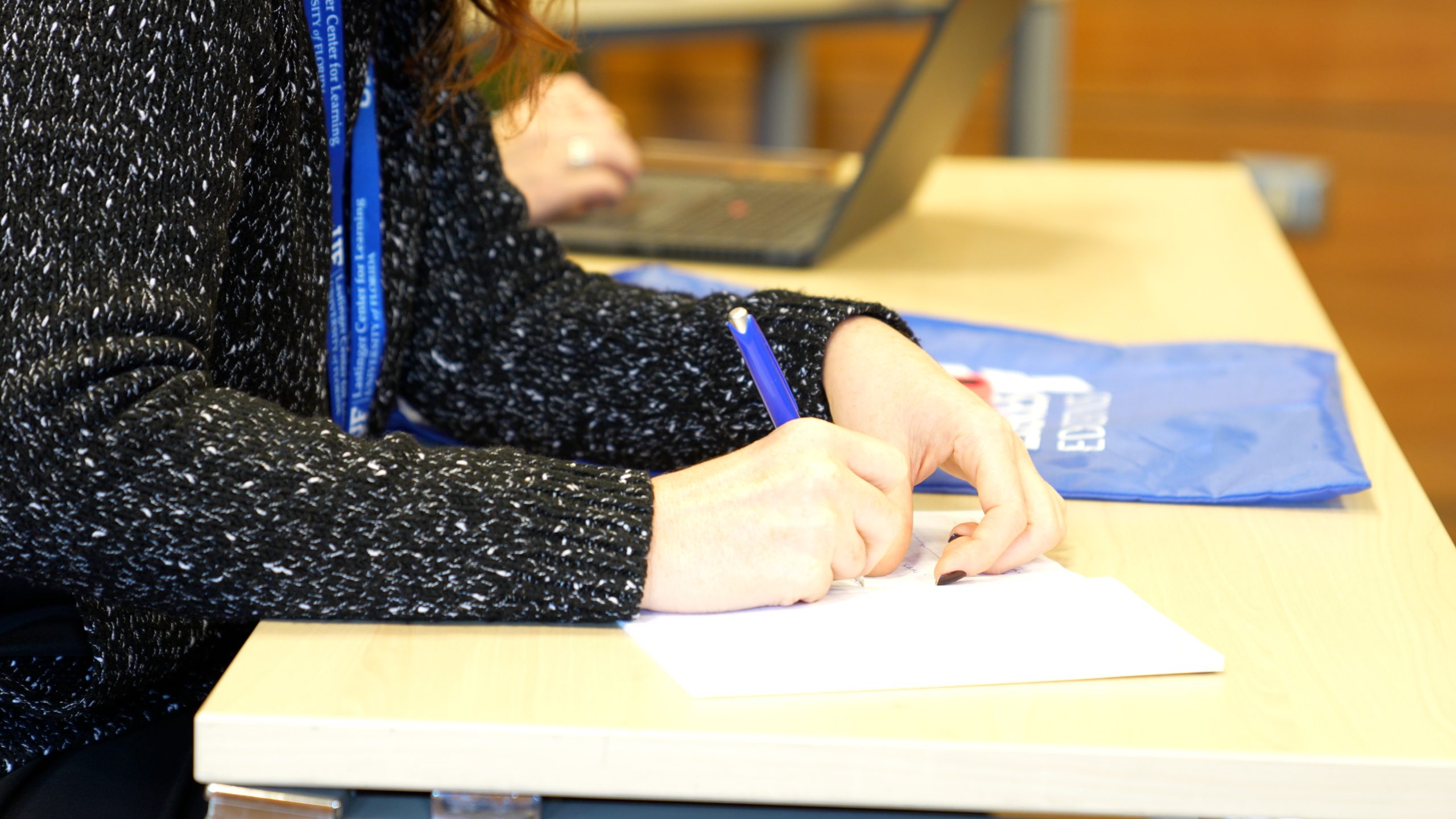 Woman writing a document on a laptop