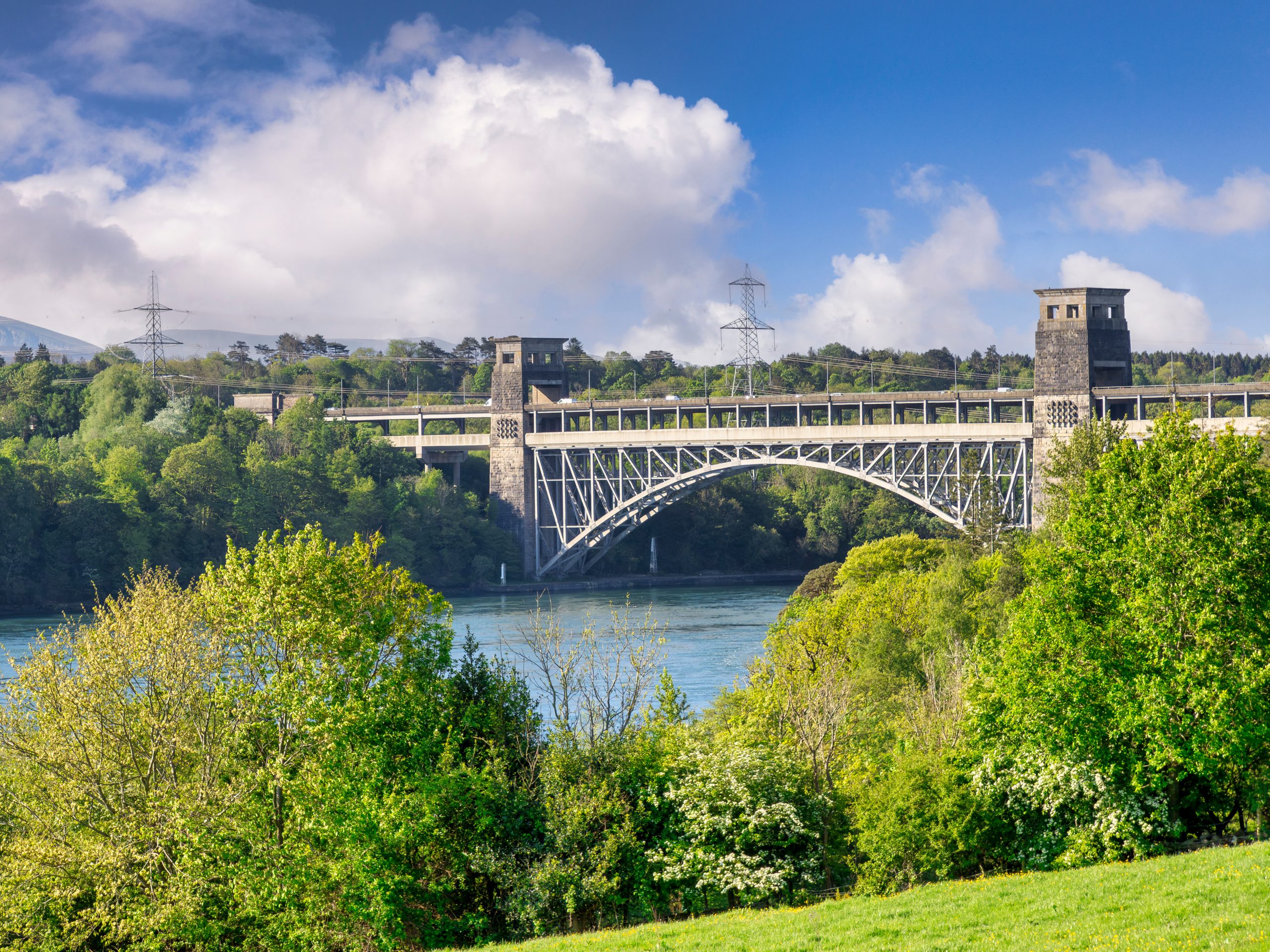 A bridge over a river connecting Anglesey , Maine and Bangor, Maine.