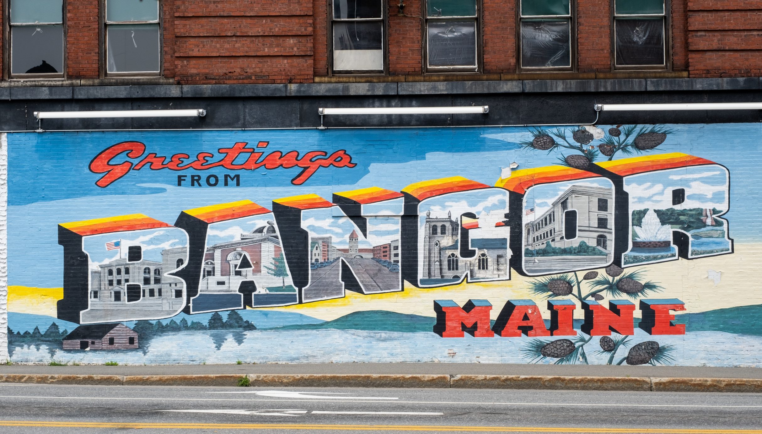 A mural in Downtown Bangor that says "Greetings from Bangor, Maine".