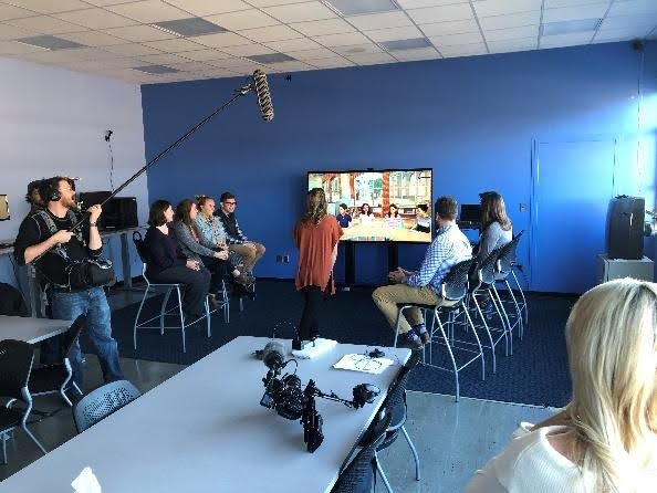 A picture of a panel of people discussing something while being recorded at the Mursion Lab.